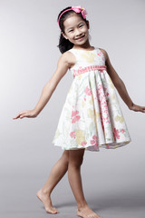 Cute Asian Chinese little girl indoors against white background