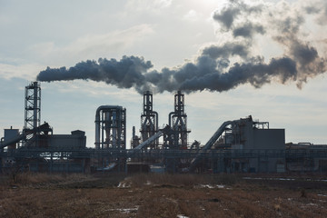 Fototapeta na wymiar Industrial plant with smoke emissions on the background of the sky.