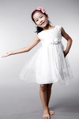 Naklejka premium Cute Asian Chinese little girl indoors against white background
