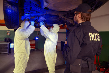 Crime investigation - collecting of evidences and traces from chassis of suspected car in police...