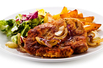 Fried pork chop with potatoes on white background