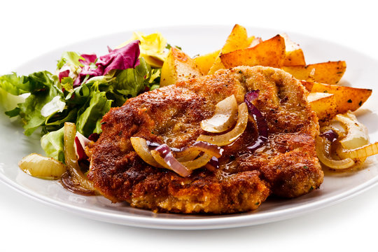 Fried pork chop with potatoes on white background