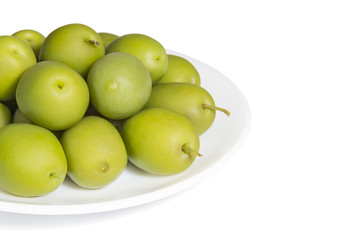 Pickled green olives on the white porcelain plate