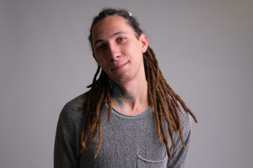 Portrait of young handsome man with dreadlocks