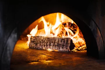 Poster Burning wood in fireplace of traditional brick pizza oven © olgagorovenko