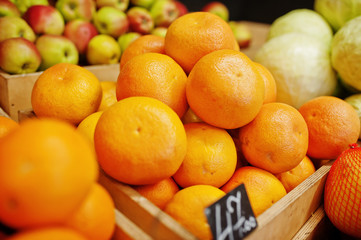 Colorful shiny fresh fruits. Oranges on the shelf of a supermarket or grocery store.