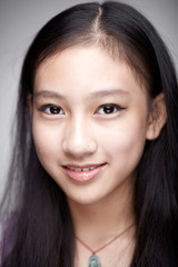 Fototapeta premium Asian teenage girl portrait. Indoors white background