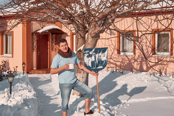 attractive middle aged smiling man with shovel and cup in his hands