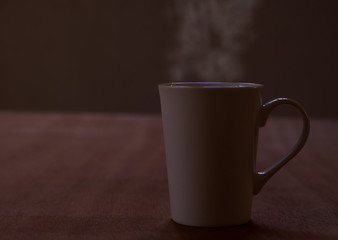 Hot coffee in a white cup on the table