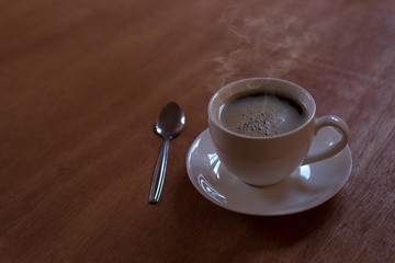 Hot coffee in a white cup on the table