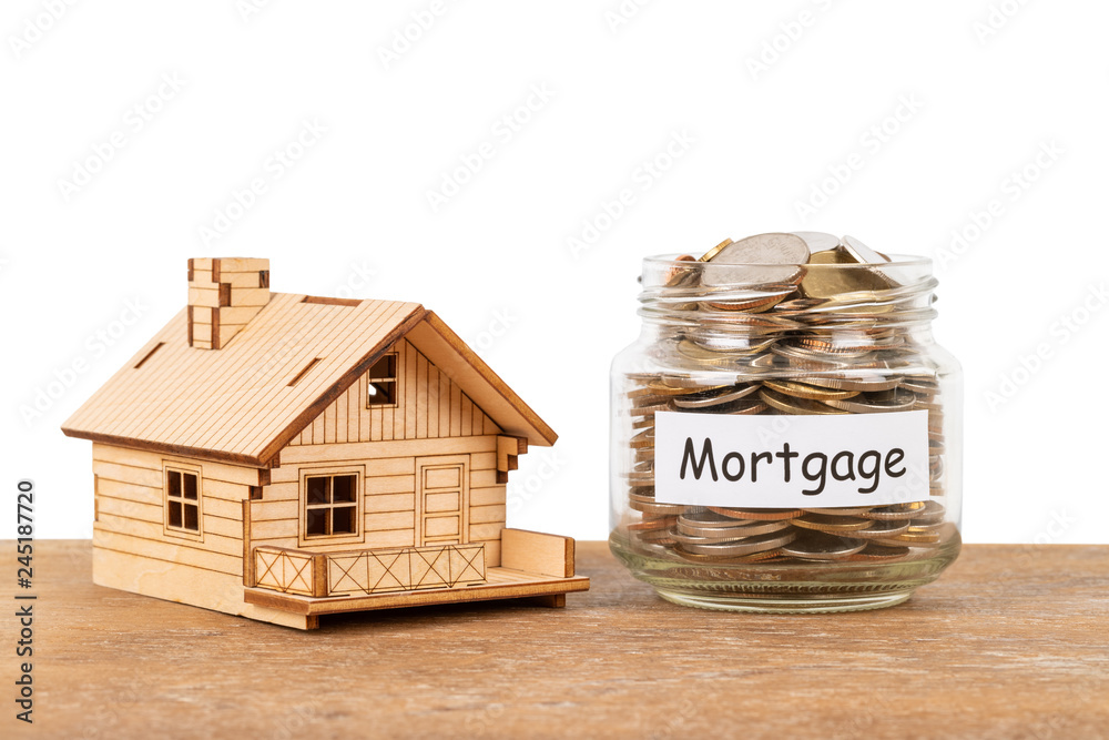 Wall mural Model house and money coin jar on white background mortgage saving concept