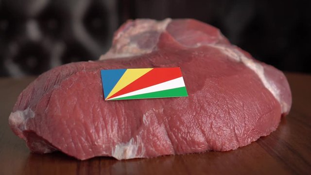 Raw meat and flag of Seychelles. Beef and Cattle. Global trade