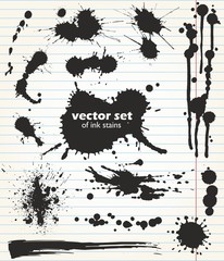 Paint spots of different size and shape. Useful set of black ink stains. Collection of grungy design elements on the background of notebook sheet.