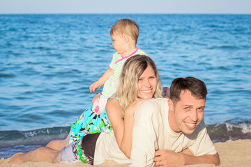 Fototapeta na wymiar happy family playing on the sea in nature