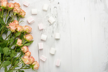 Valentine's Day. The frame is made of roses flowers and sweets on a marble background. Valentine's day background. Flat lay, top view, copy space