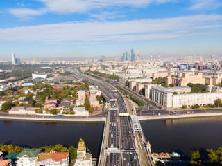 Obraz premium panorama high-rise buildings and transport of metropolis, Frunzenskaya Embankment and the Third Transport Ring, cars on multi-lane highways and road junction in Moscow.