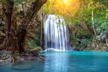 Fototapeta na wymiar Erawan waterfall in Thailand. Beautiful waterfall with emerald pool in nature.