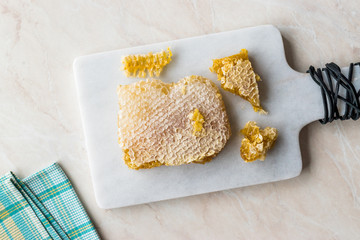 Fresh Honeycomb Slices with Honey on Marble Board.