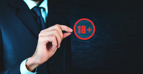 Man holding magnifying glass with 18+ text.