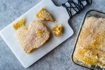 Fresh Honeycomb Slices with Honey on Marble Board.