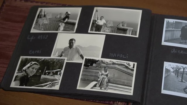 Slow overview of vintage photo album with family FDV