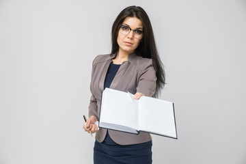 Naklejka premium young girl stretches out ahead the day planner isolated on light background