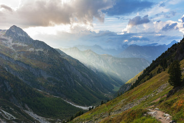 Mountains in the Swiss Alps with glaciers, rivers and distant mountain valleys.