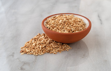 Cut orris root in a bowl and spilled on a marble counter top