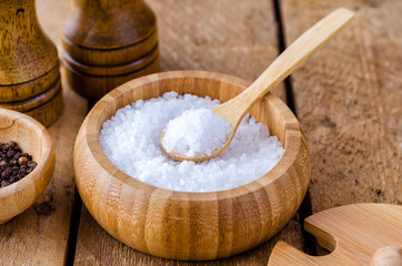 Fototapeta na wymiar Sea salt in a wooden bowl.