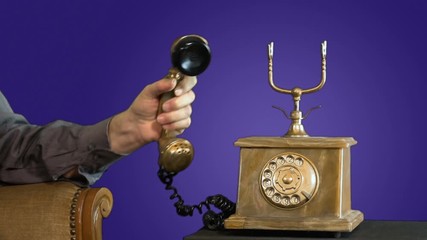 A man is calling friends by a vintage phone with a purple background MF - Powered by Adobe
