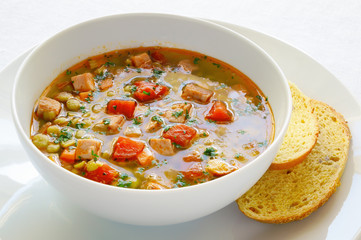 pea soup with pork and vegetables served with corn bread
