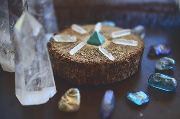 Bright, healing crystals and palo santo. Mystical, low exposure macro photo of crystals. Healing stones, witchy decoration. Wiccan alter, bohemian colors, crystal witchcraft.