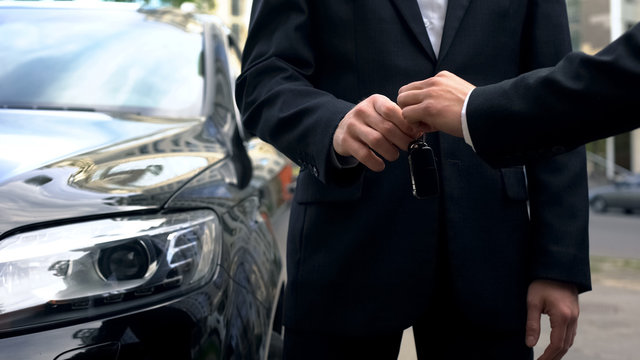 Businessman Taking Keys To Expensive Auto, Successful Car Purchase Transaction