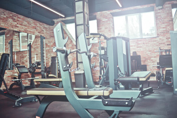 Modern gym. Sports equipment in gym. Loft style