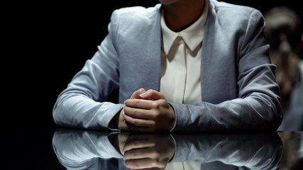 Female television presenter reporting breaking news in broadcasting studio