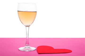 Glass and red paper form of heart for Valentine's Day