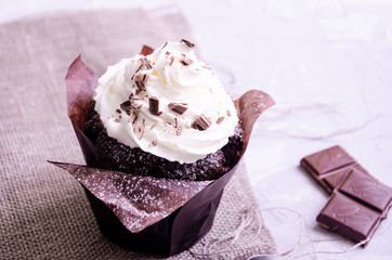 chocolate cupcake with cream, powdered sugar and berries