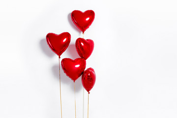 Set of Air Balloons. Bunch of red color heart shaped foil balloons isolated on white background....