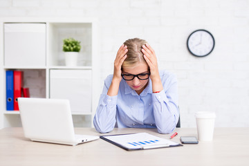 tired business woman sitting in office