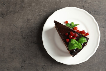 Plate with slice of tasty homemade chocolate cake and space for text on table, top view