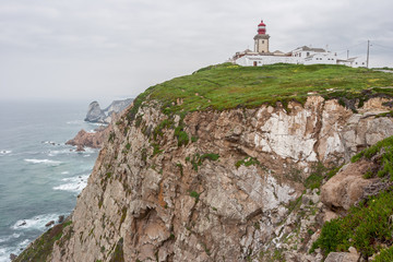 Fototapeta na wymiar Lighthouse on cliffs at Cabo da Roca (Cape Roca) in Portugal