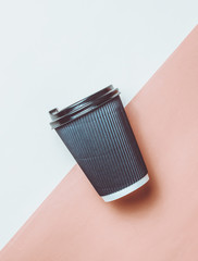 Paper coffee glass on a colored paper background. Top View