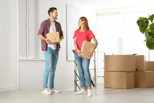 Couple with moving boxes in their new house