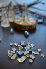 Hipster healing crystal display, bright shiny gems and stones. Witchy crystal healing and meditation. Sacred space, Wiccan alter. Clear quartz, aquaaura, rainbow aura quartz. 