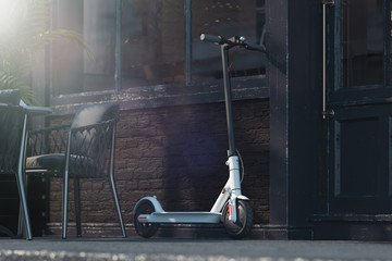 Electric scooter on cityscape background. eco transport concept. 3d rendering © ekostsov