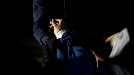 Male criminal opening car trunk and checking female victim pulse, kidnapping © motortion