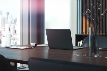 Black modern laptop on wooden table in contemporary office, 3d rendering.