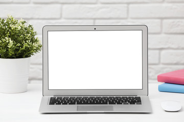 Fototapeta premium Laptop with blank screen on table indoors. Space for text