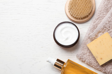 Flat lay composition with body care products and space for text on white wooden background