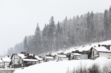 Beautiful view of mountain ski resort with many cottages. Winter vacation